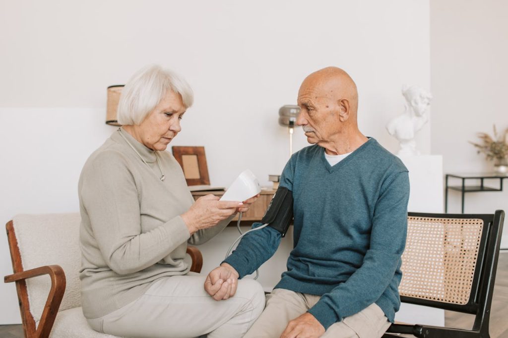 A Man in Blue Sweater Checking His Blood Pressure